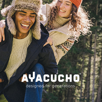 Shop Ayacucho collection. Two people in playful motion in a woodland setting