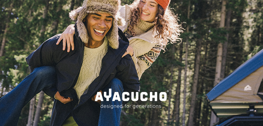 Shop Ayacucho collection. Two people in playful motion in a woodland setting