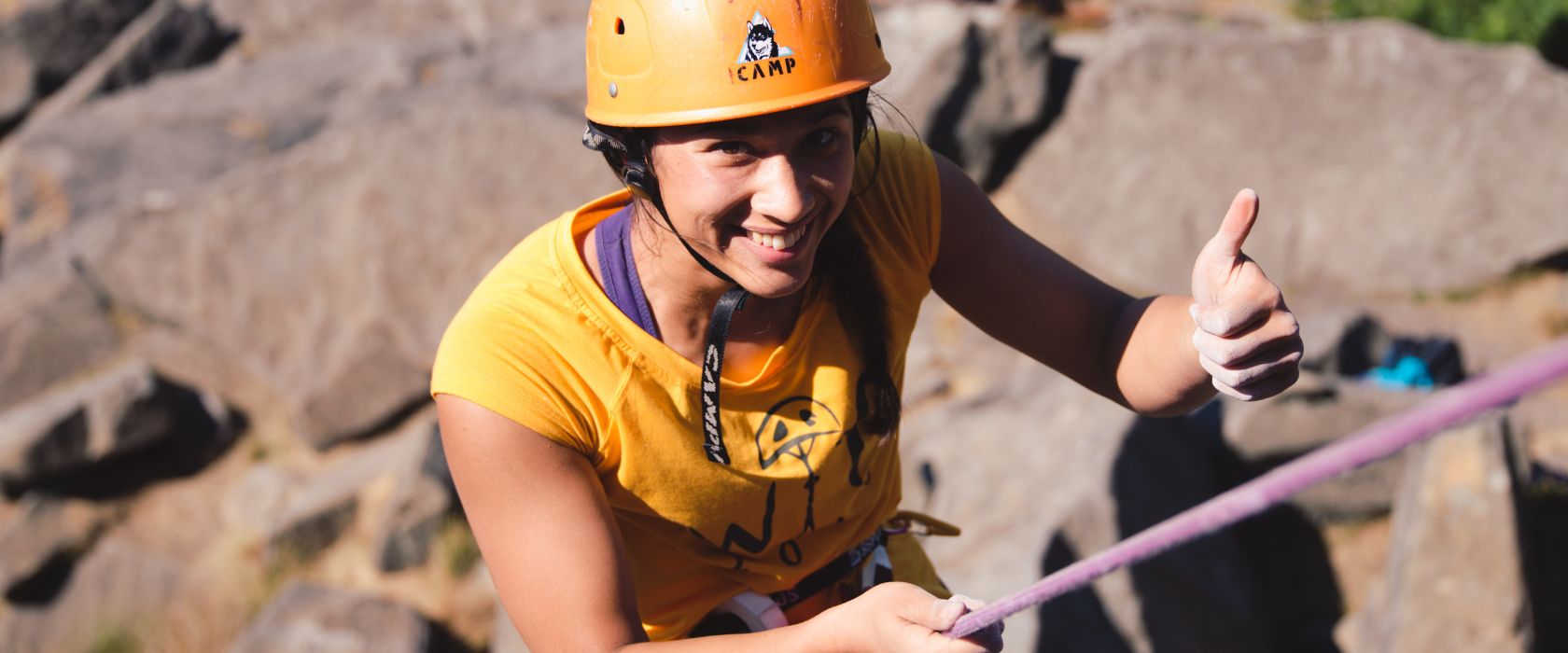 person climbing a rock wall