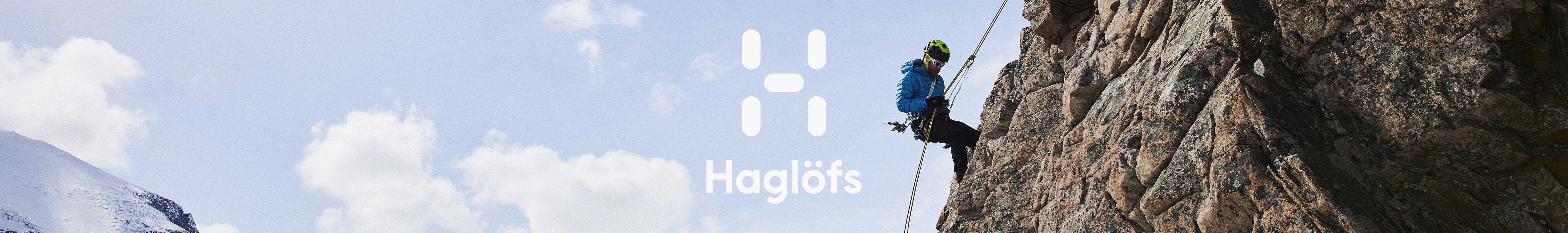 Haglofs brand page header image. A man climbing down a cliff face 