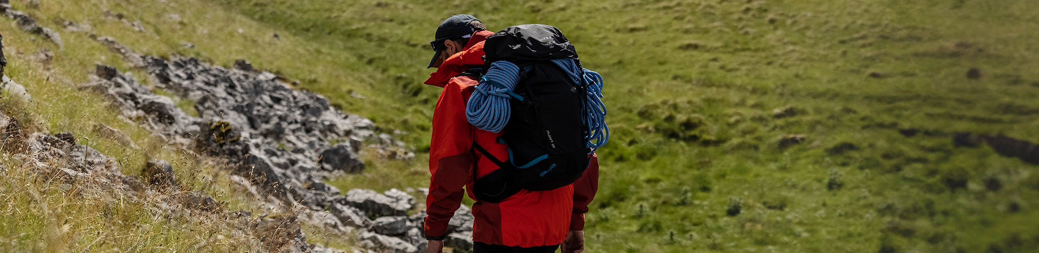 Shop Packs and Luggage. A hiker with backpacks on a hill 