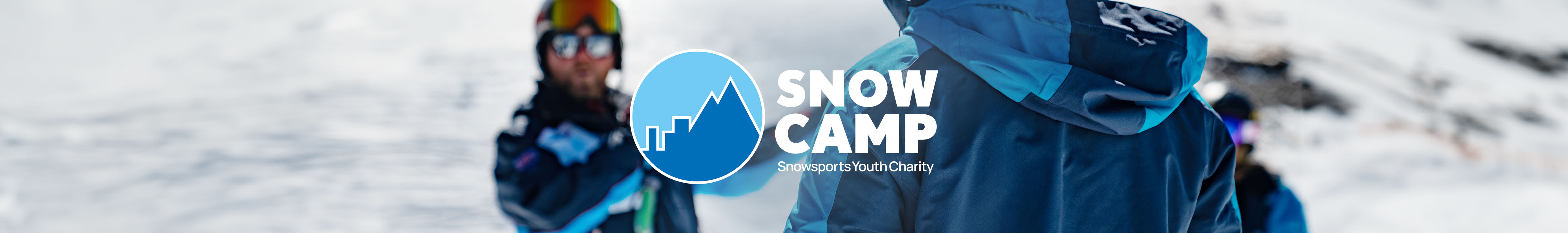 Snow Camp. People are in a ski resort, wearing skiing gear.  