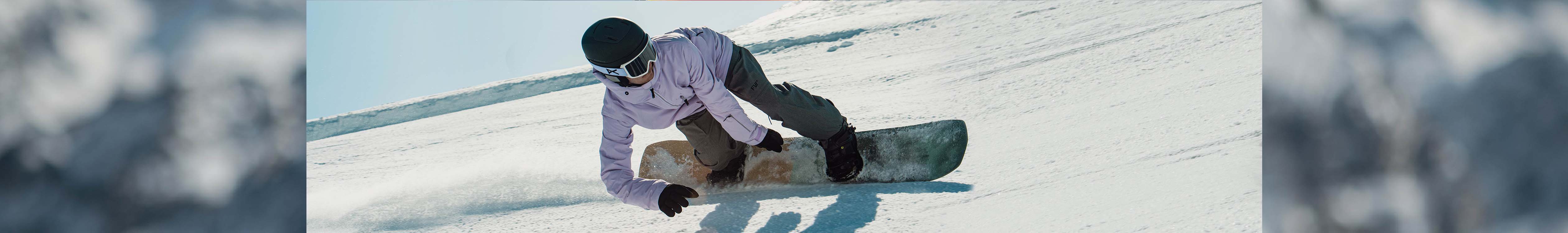 Snowboard sale. A snowboarder racing down the slope