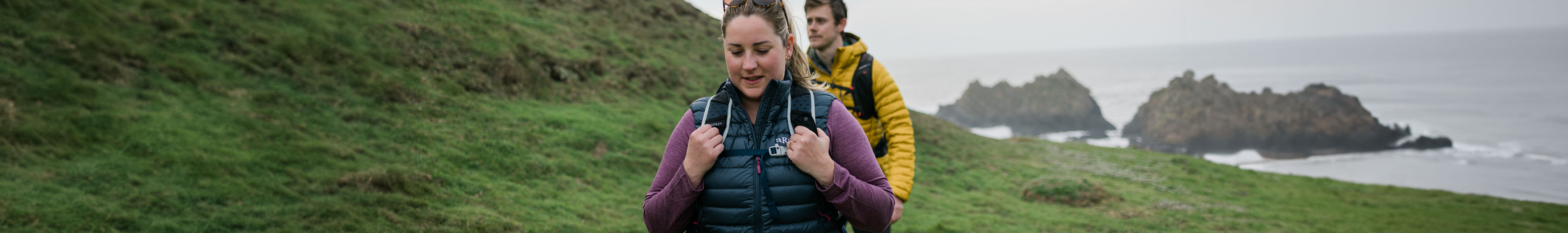 New season Insulated jackets. Man and woman in insulated jackets on a hike. 