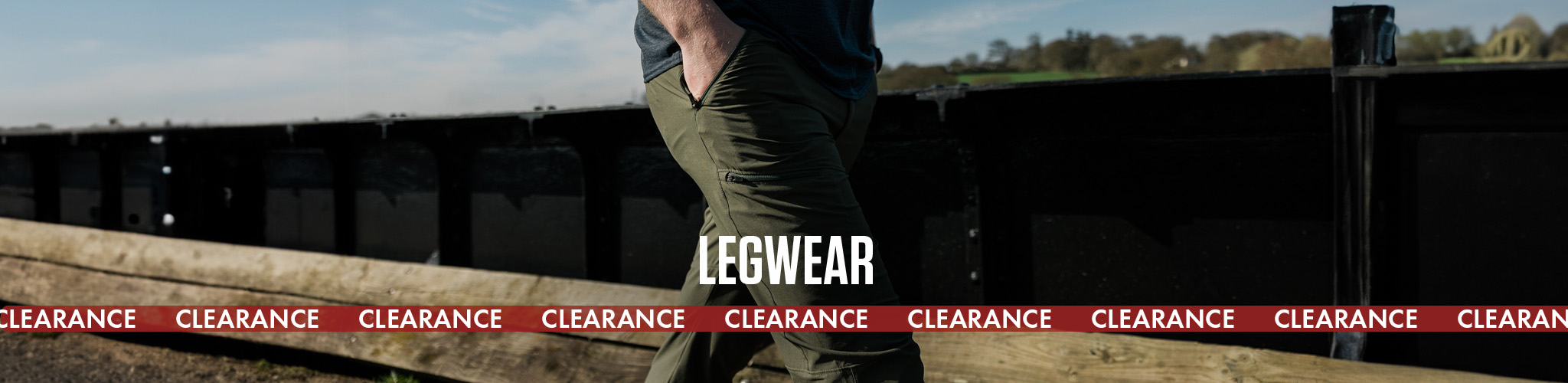 Shop legwear clearance. A person wearing trousers with their hands in their pockets 