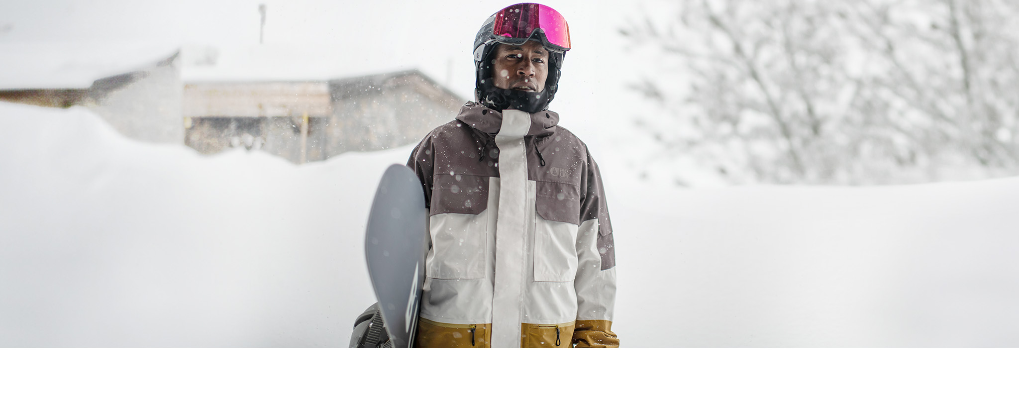 Shop for snowboarders. A man and his snowboard wearing a snowboarding helmet, goggles and a snow jacket