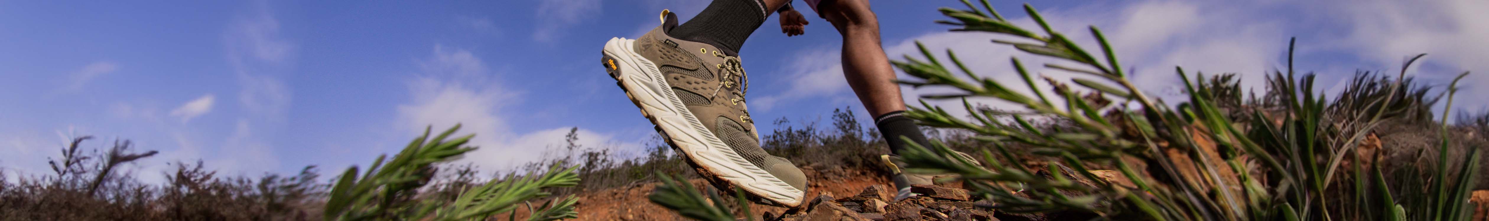 Casual footwear. Person's feet is casual shoes, walking on a path