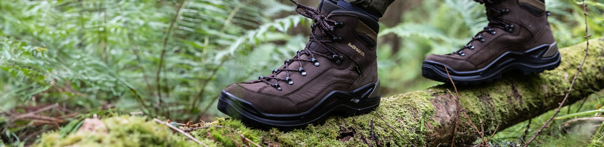 Shop hiking boots. A person walking along a log in their Scarpa boots 