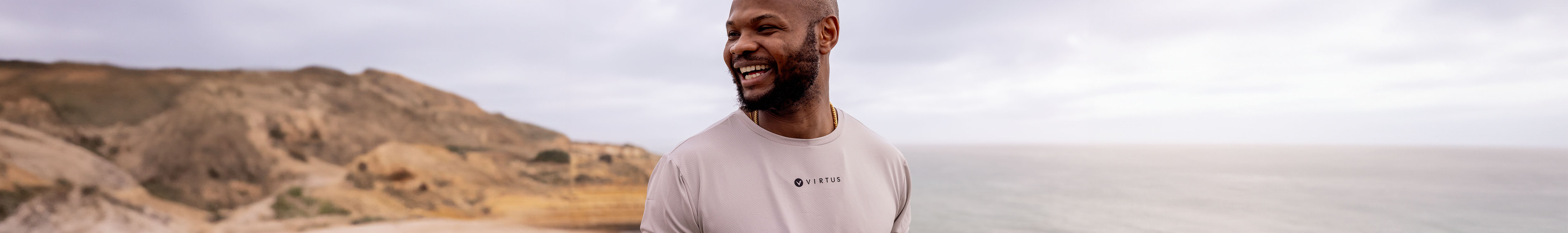 Tops summer styles. A man is in a t-shirt on a beach