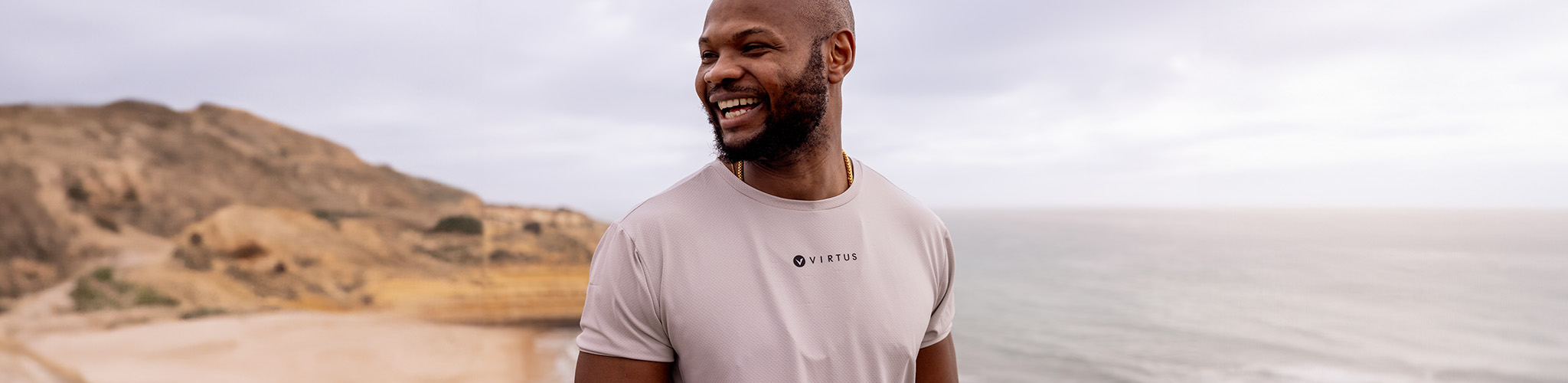 Tops summer styles. A man is in a t-shirt on a beach