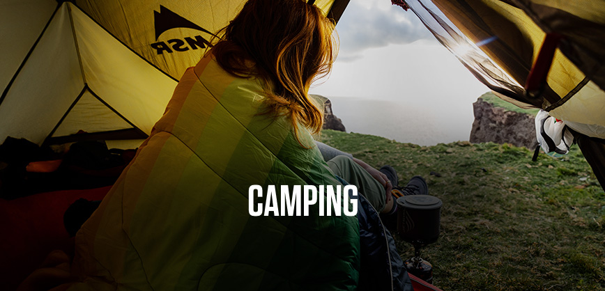 Shop camping. A woman looking out of a tent