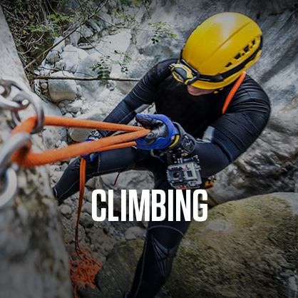 Shop climbing. A man climbing in climbing gear on a side of a rock. 