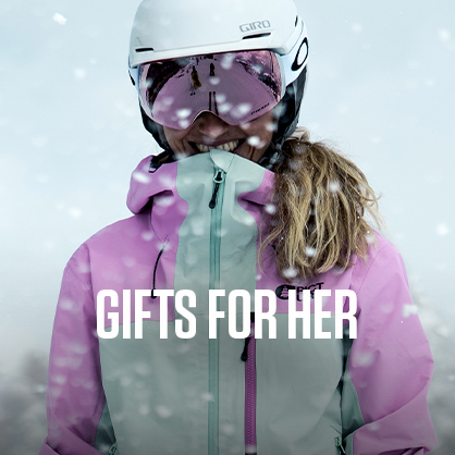 Shop gifts for her. A woman standing outside in a snow wearing Picture jacket, helmet, and goggles