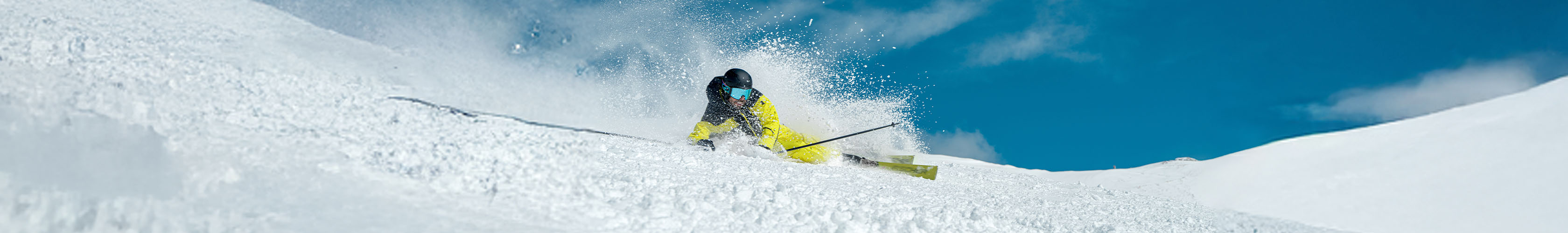 Shop Avalanche safety. A person is skiing down a slope, wearing skiing gear