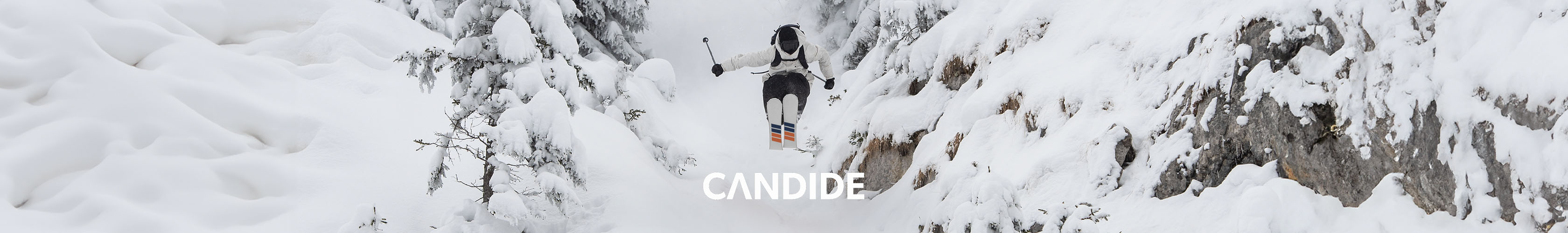 Shop Candide Skis. A person jumping, while skiing in Candide skis