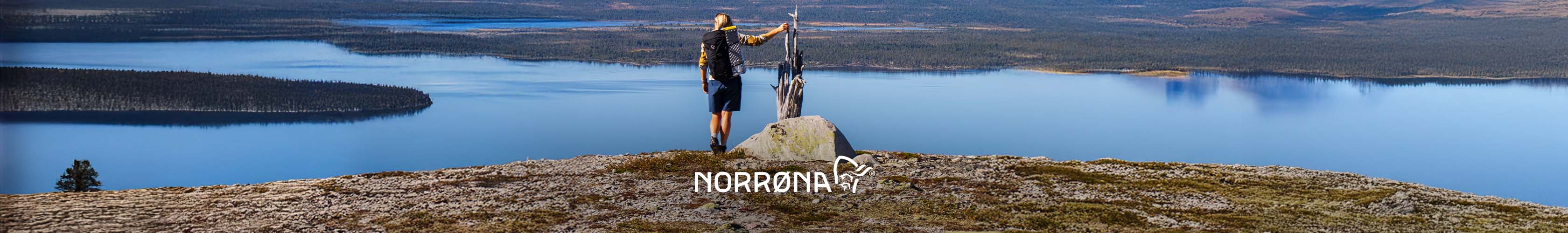 Norrona brand page. A person standing on a cliff looking at the lakes below