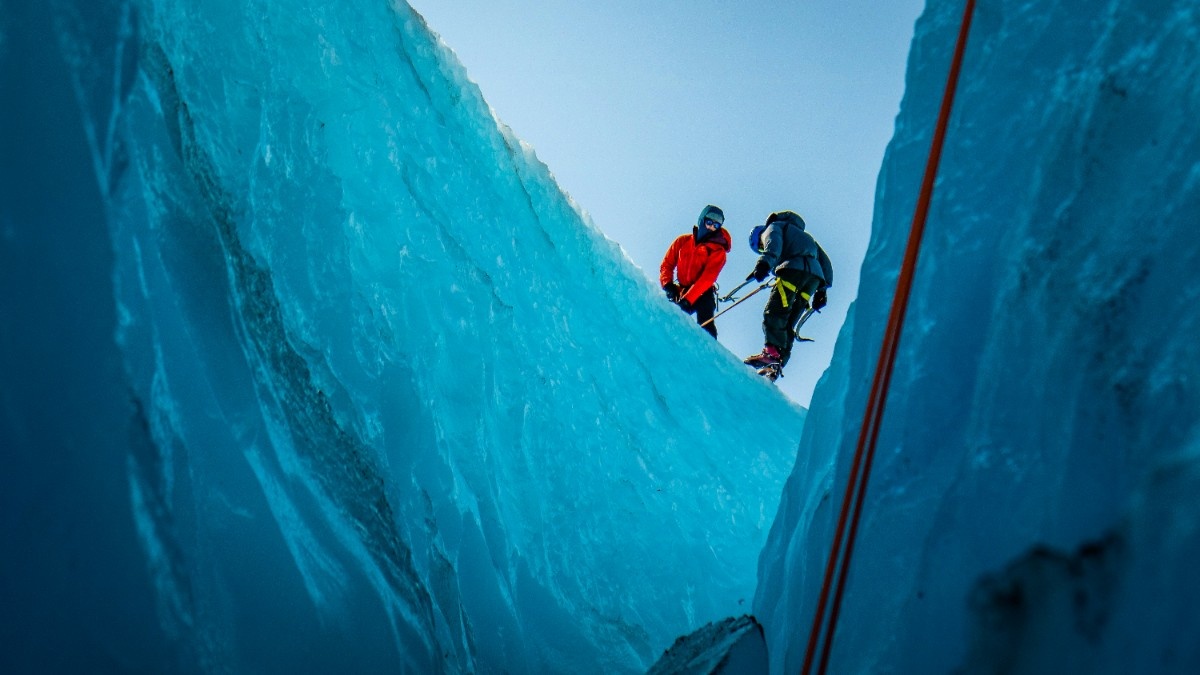 Two people at the top of a glacial climb 