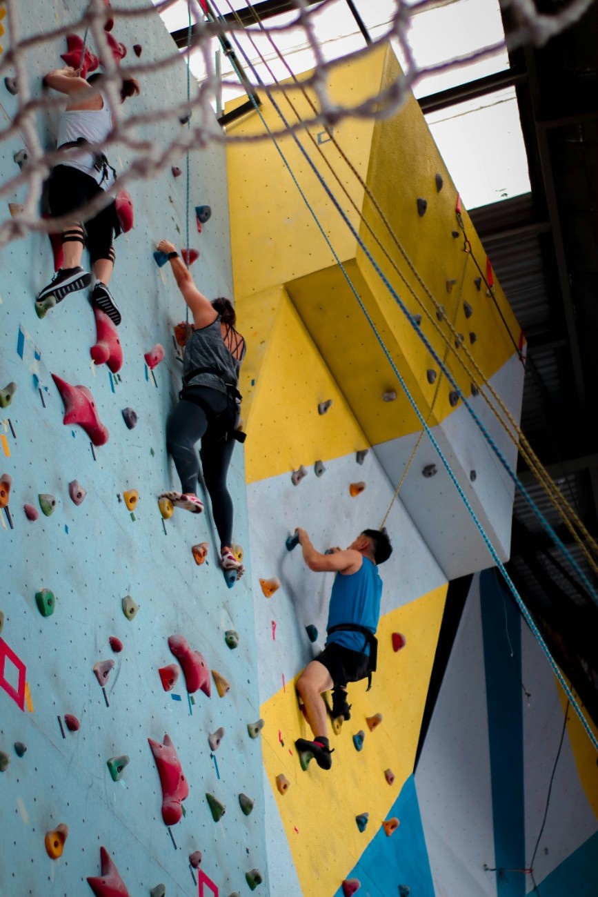 A group of people indoor climbing