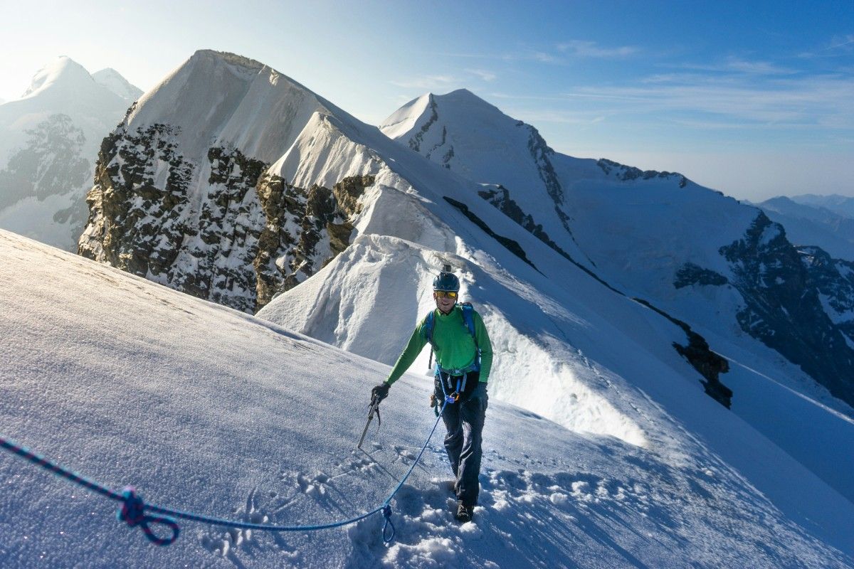 A person mountaineering on a snowy mountain