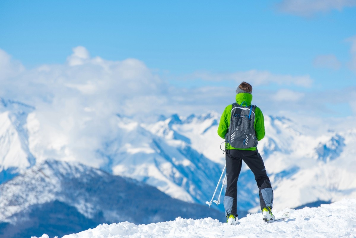 A person stood atop a snowy mountain 