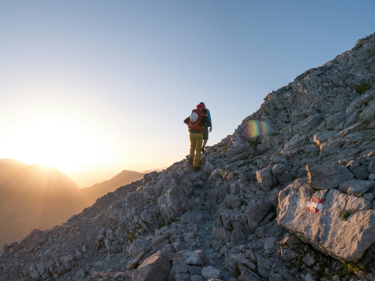 A mountaineerer in front of the sunset 