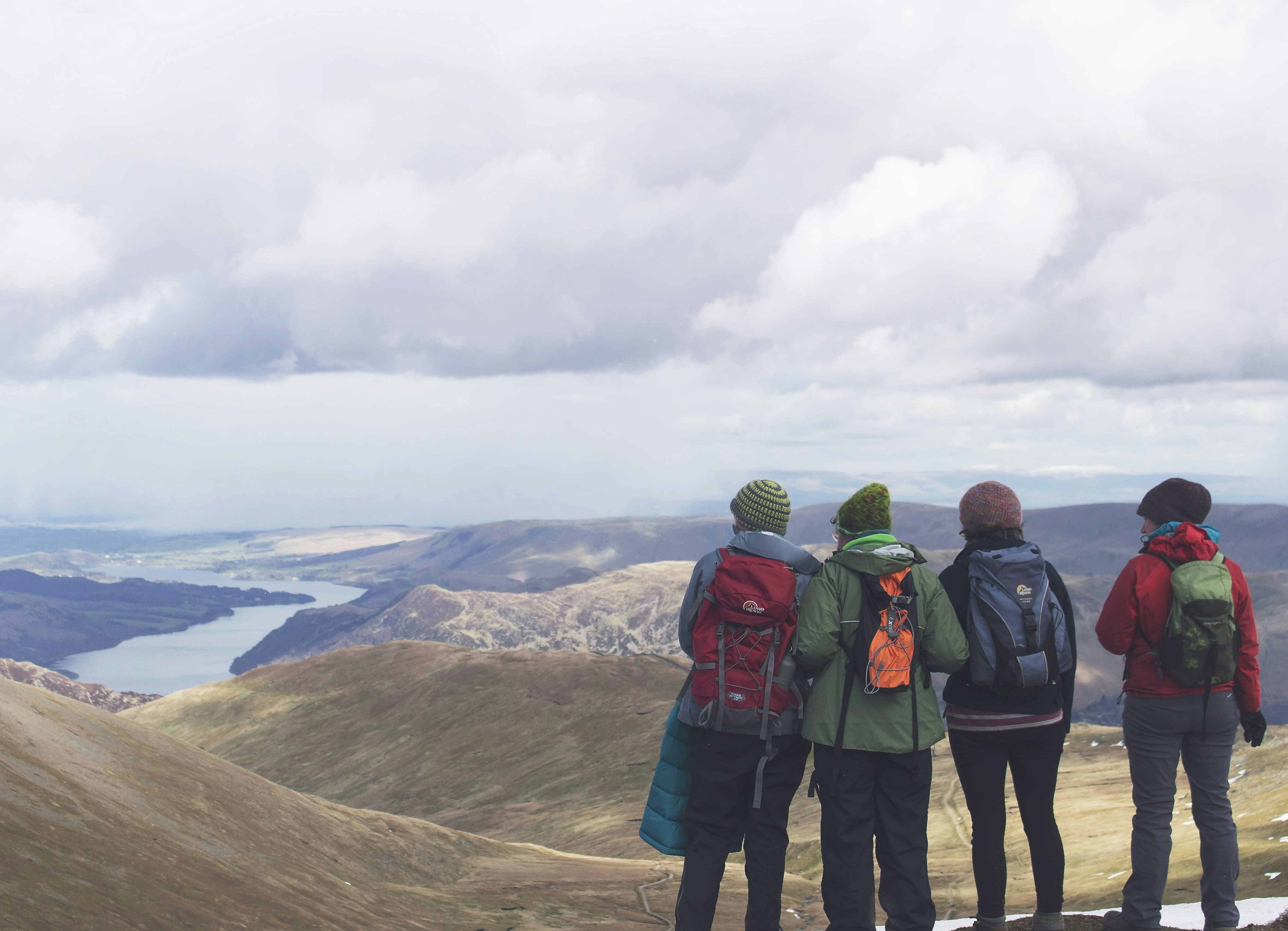 Four friends standing on the peak of Helvellyn 