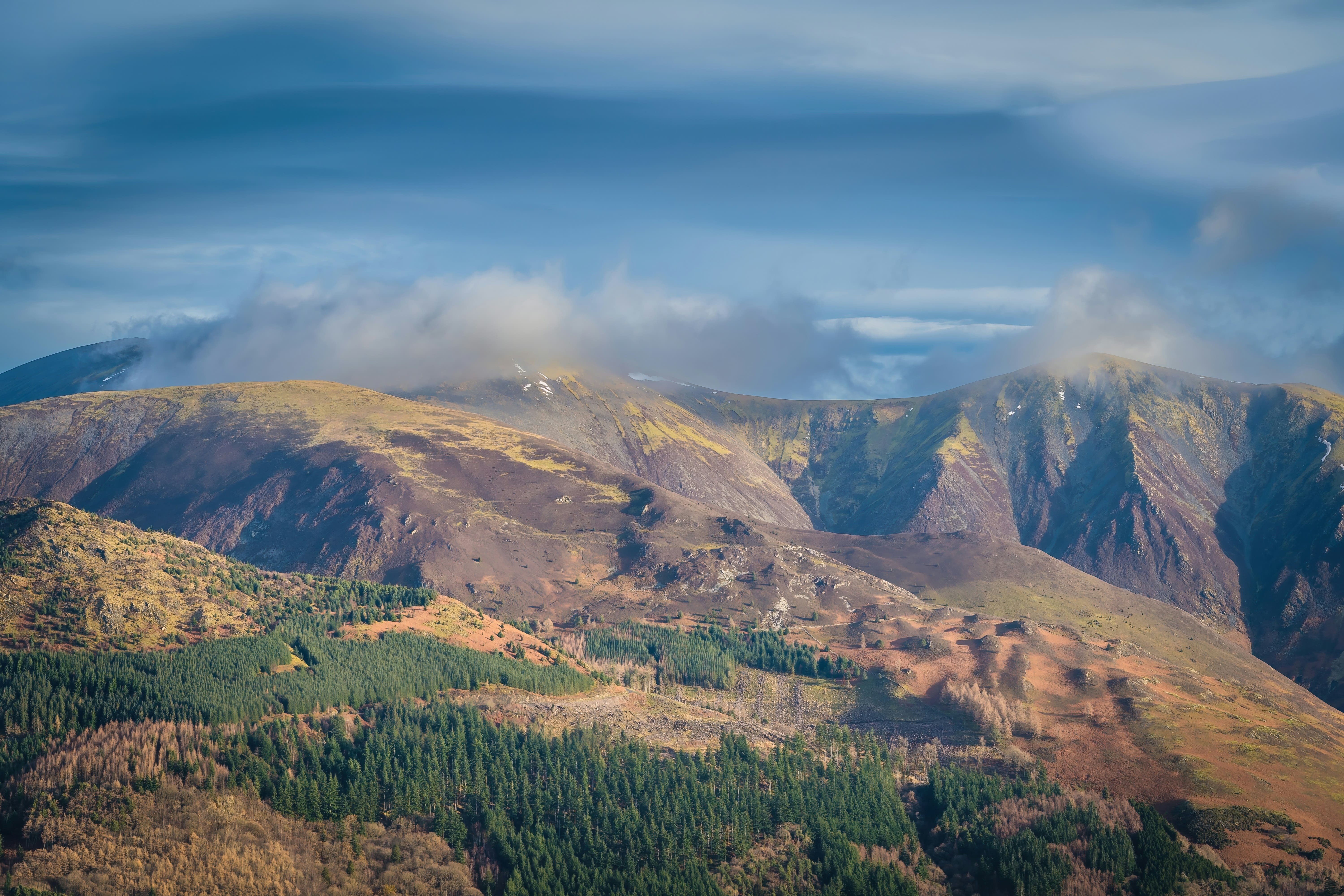 An image of Skiddaw with a cloud coming over the top of the summit 