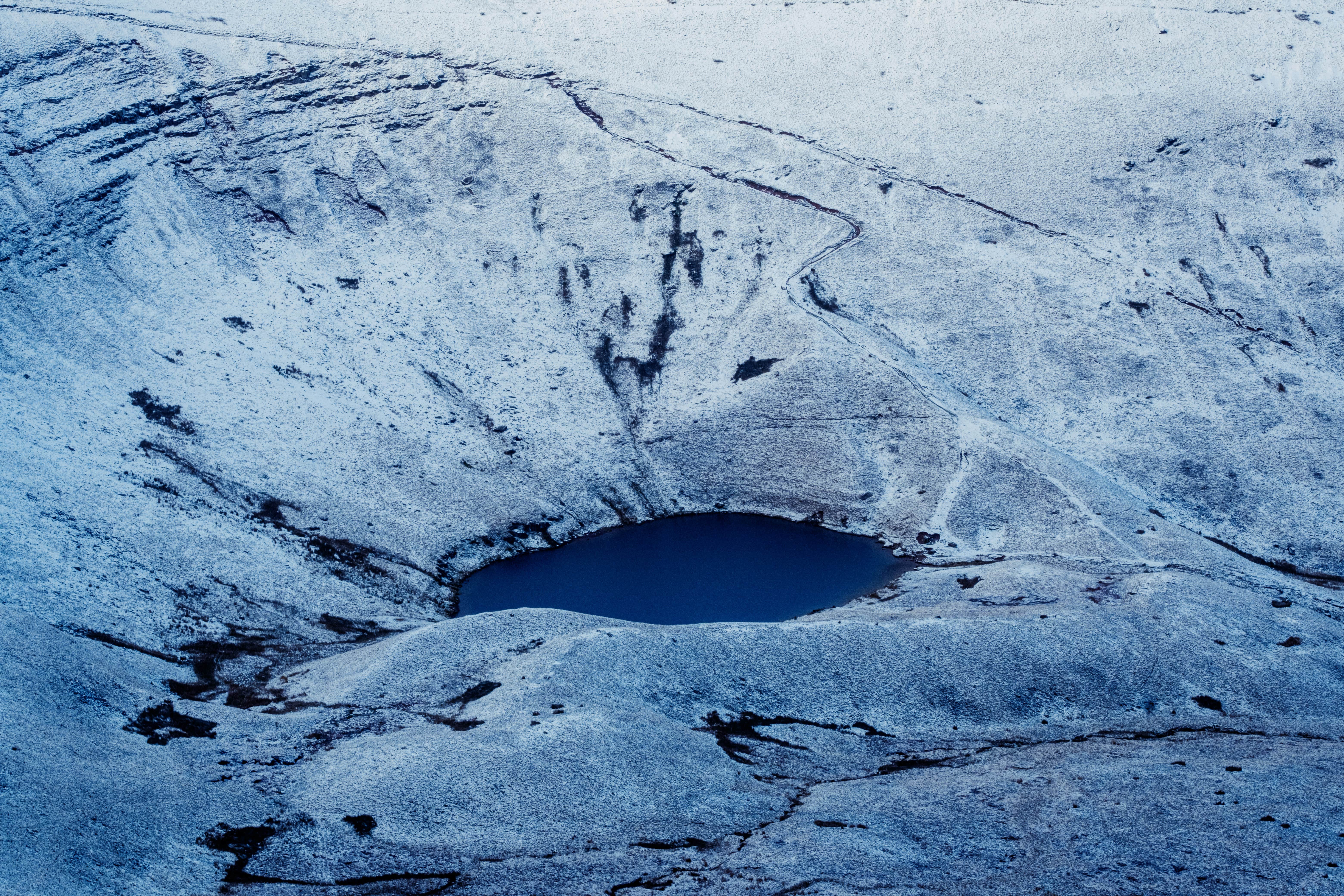 An image of a lake near Pen Y Fan, frozen over in the winter