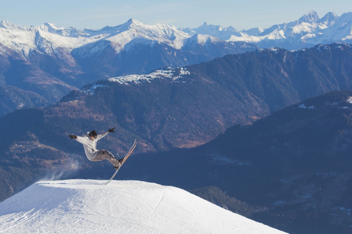 A person doing a trick on his skis at Laax Ski Resort