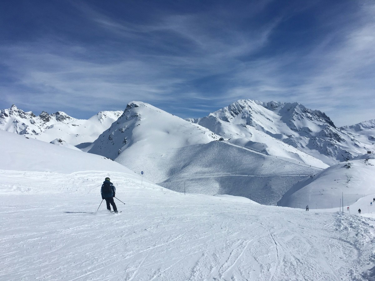 A person skiing down the piste at Les Menuires ski resort