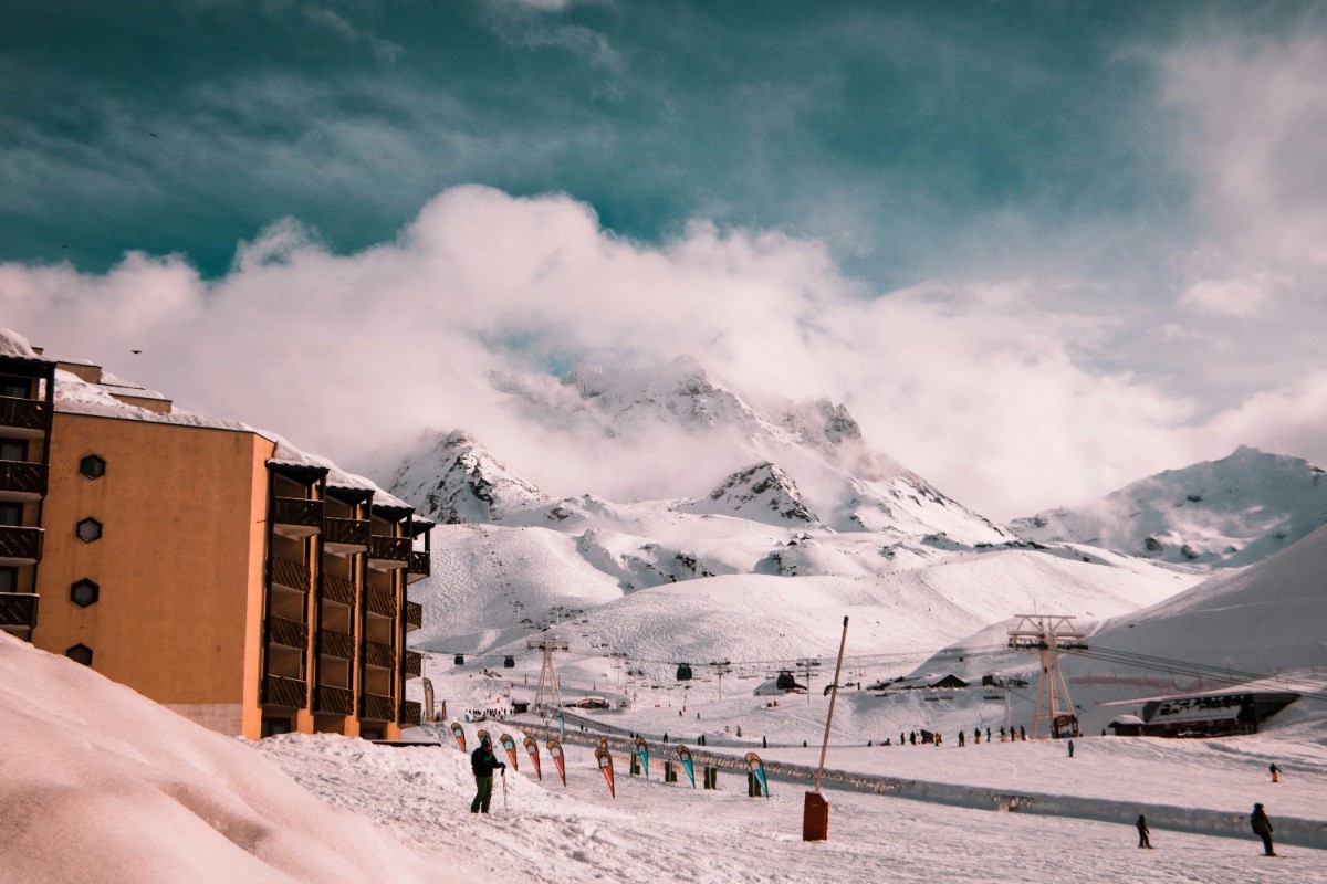 A hotel in Val Thorens with a misty sky over the mountain in the background