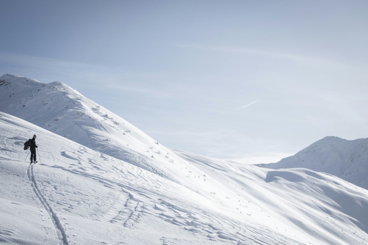 A person walking through the Swiss Alps at Verbier in the snow 