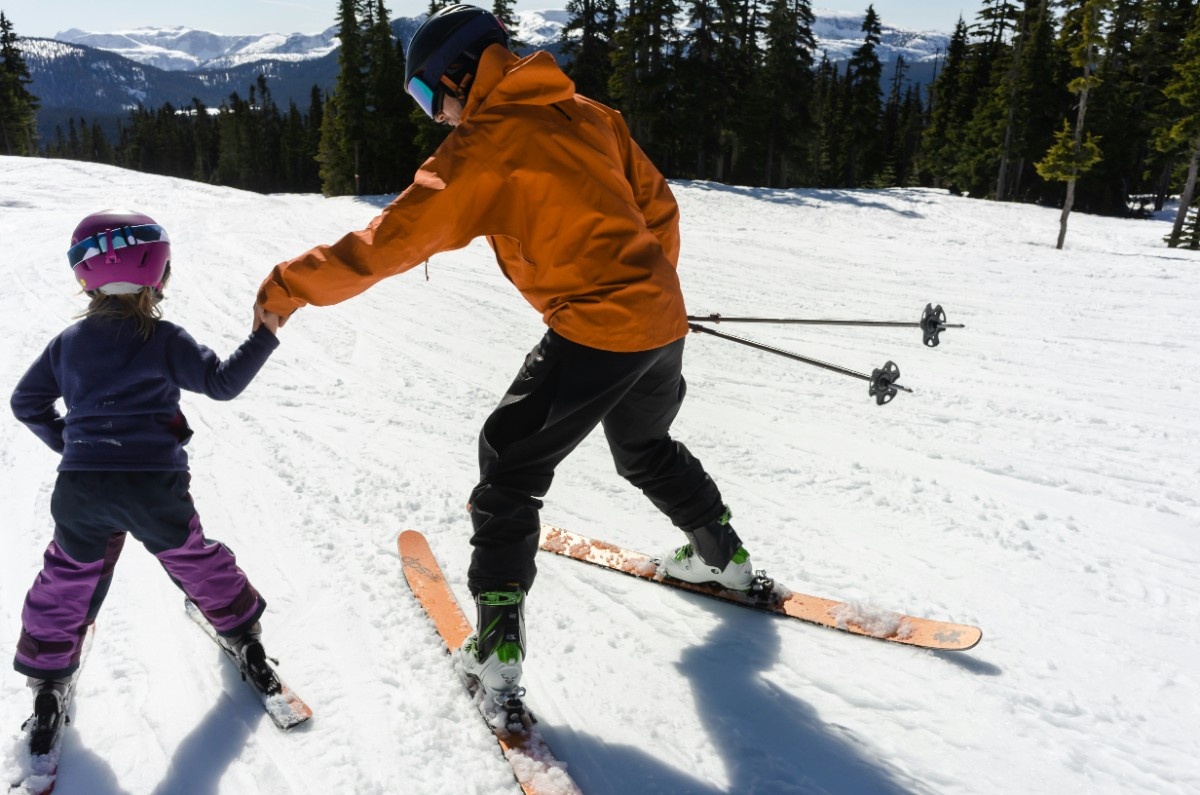 A parent and child skiing