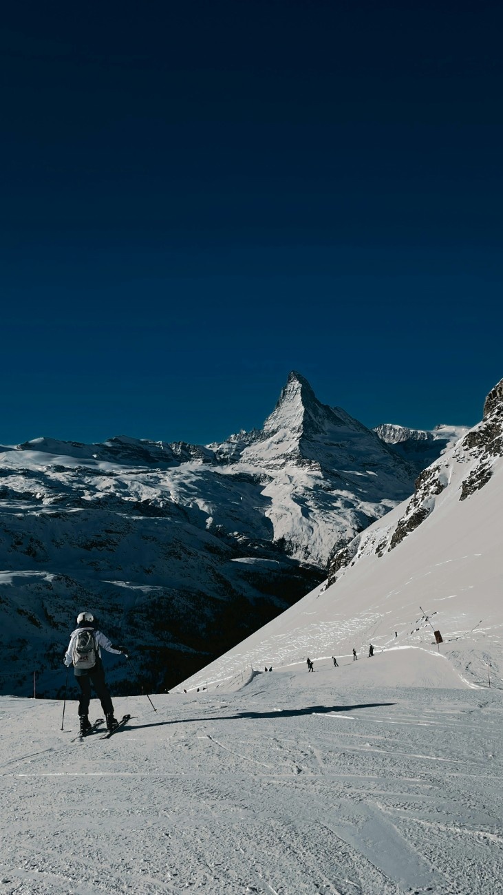 People skiing in Zermatt with the Matterhorn in the distance 